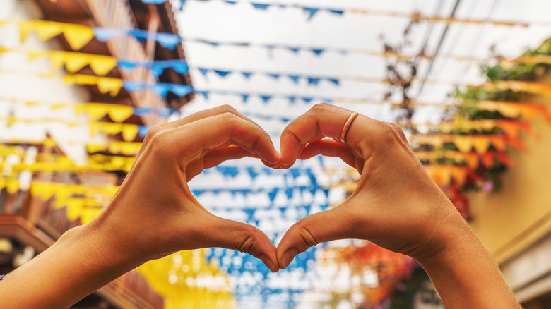 person making hand heart shape