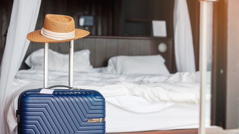 Luggage and hat in hotel room