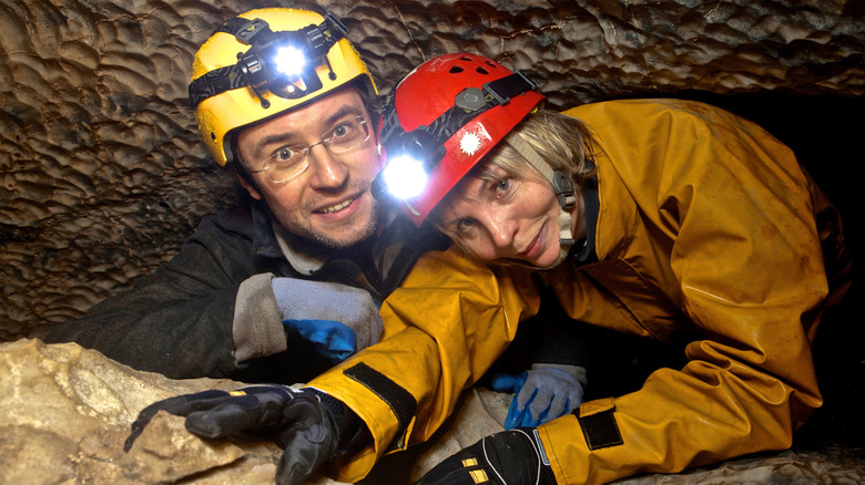 man and woman wearing headlamps 