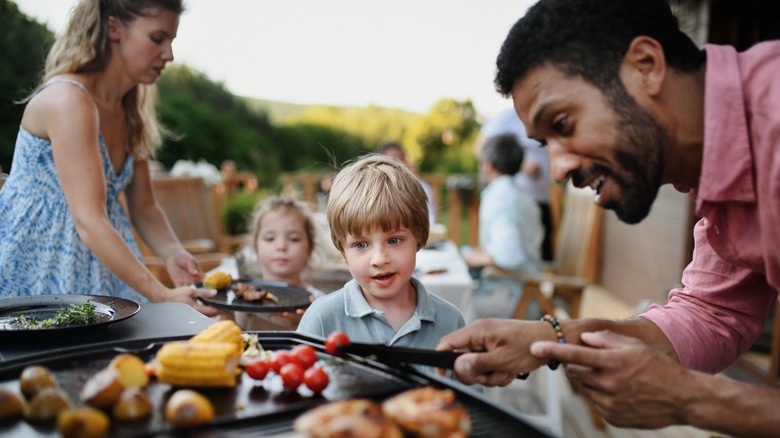 Family at an outdoor grill