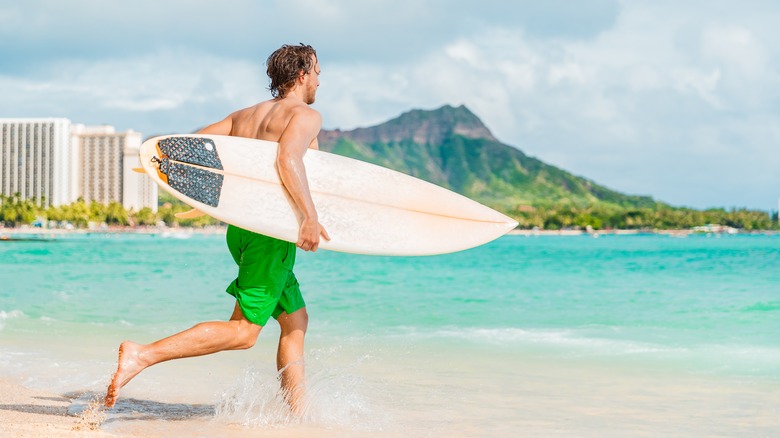 Man with surfboard on Oahu