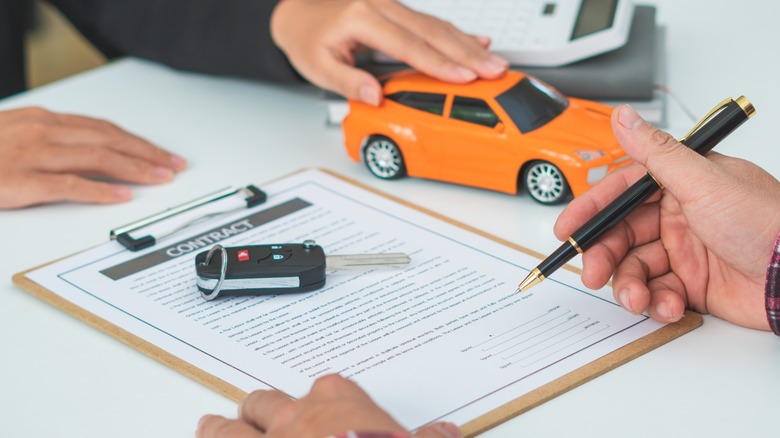 Person signing car rental contract