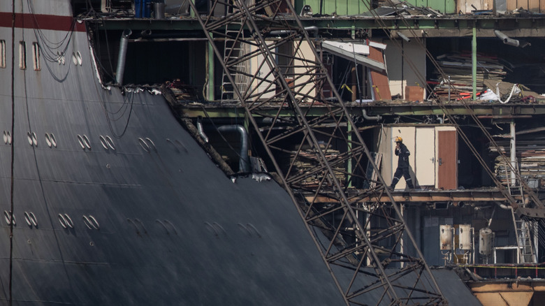 worker in partially demolished  ship