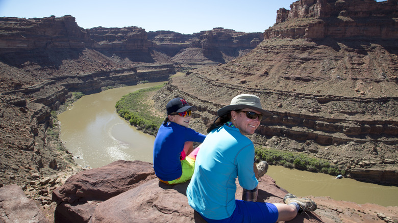 Hikers sitting on the edge of Cataract Canyon, Utah