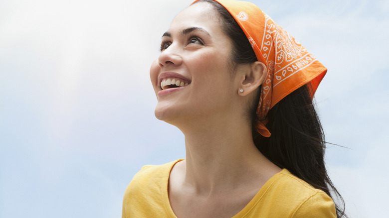 Traveler wearing bandana around their head