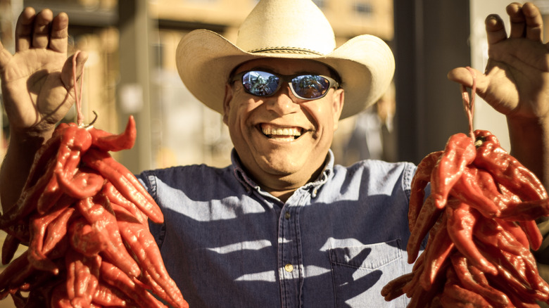 man holding chile ristra