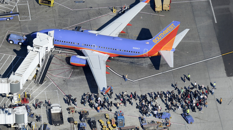 People leaving an airplane on the tarmac