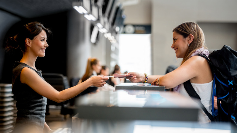 Woman purchasing ticket at the airport