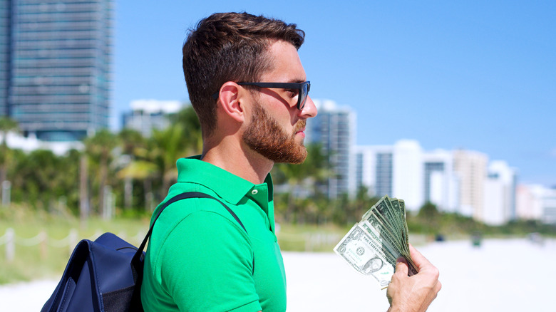 Tourist holding US dollars