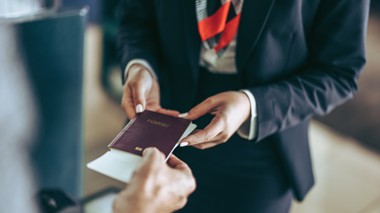 Flight attendant taking passport