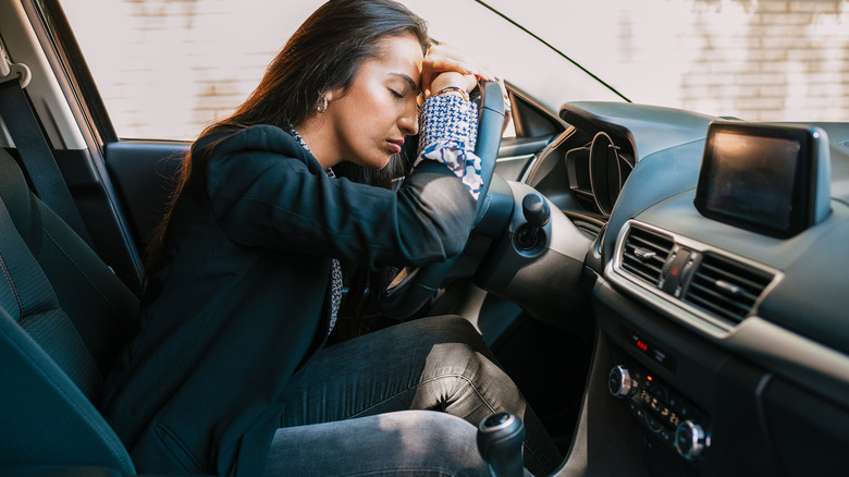 Stressed driver sitting in rental car