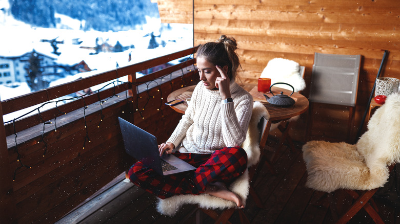 Woman on laptop in winter