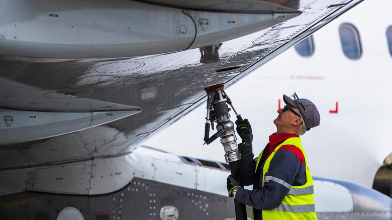 Person refueling a plane