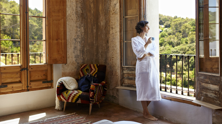 Woman by window of hotel