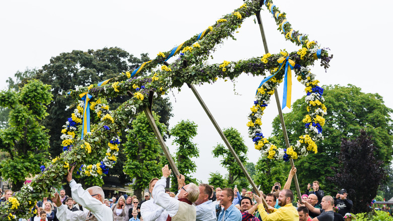 People raising maypole in Sweden