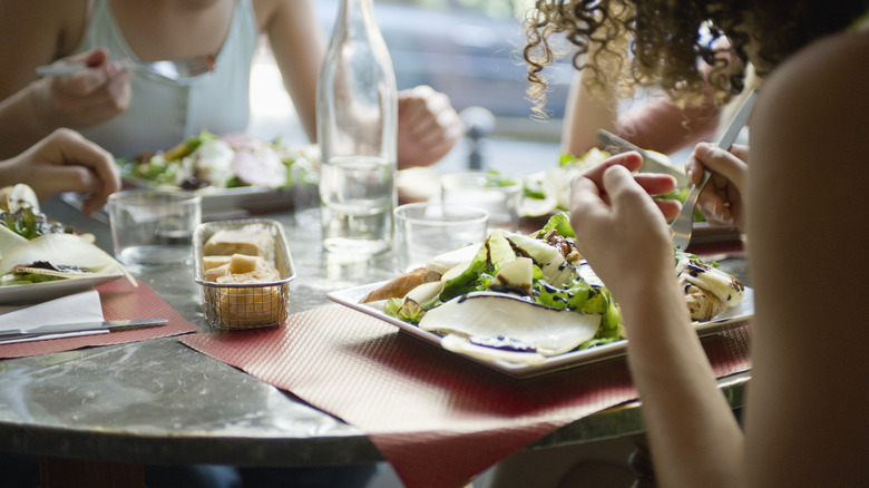 women eating salads at a Paris bistro