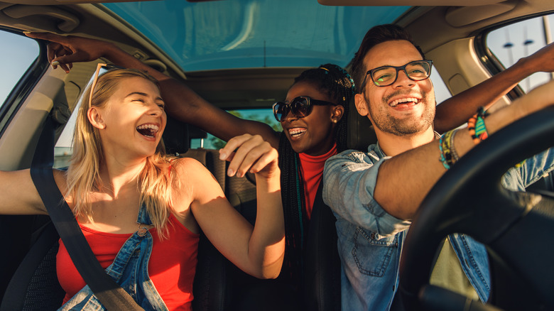 Smiling friends in car