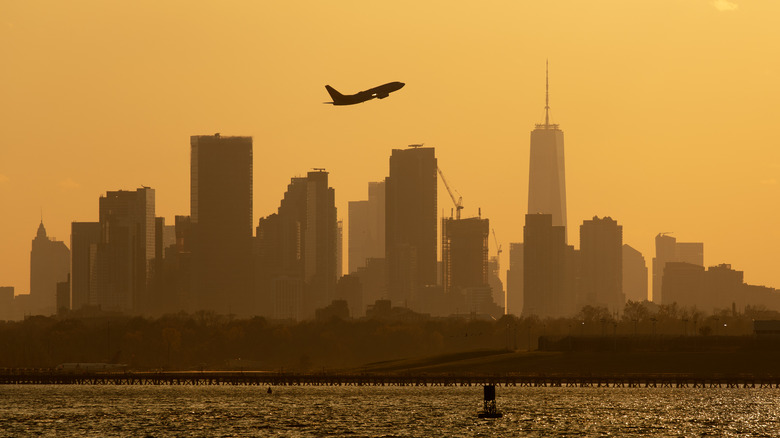 Plane rising over NYC skyline