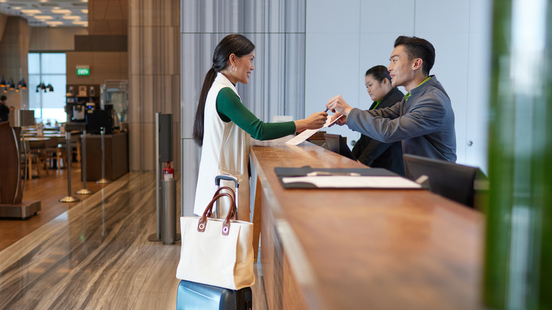 woman checking in at hotel