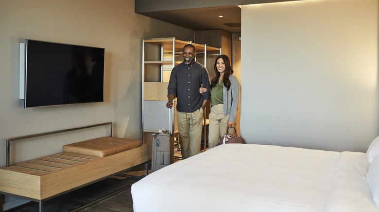 couple arriving to hotel room