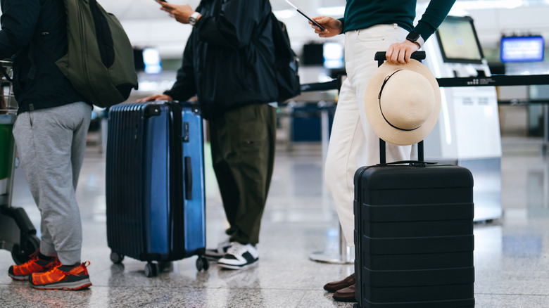 travelers in airport line