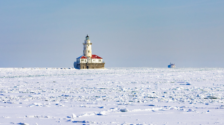 Lonely lighthouse frozen lake