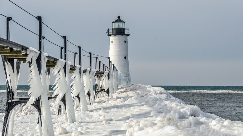 Lighthouse on frozen pier