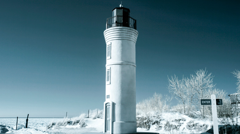 White lighthouse frozen landscape