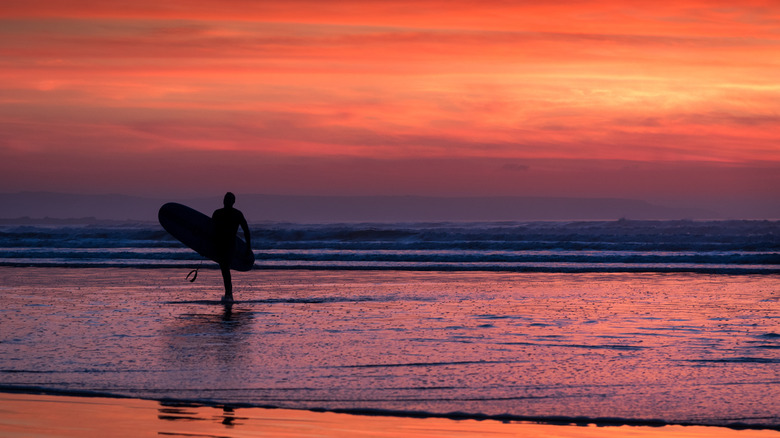Surfer at Woolacombe Beach sunset