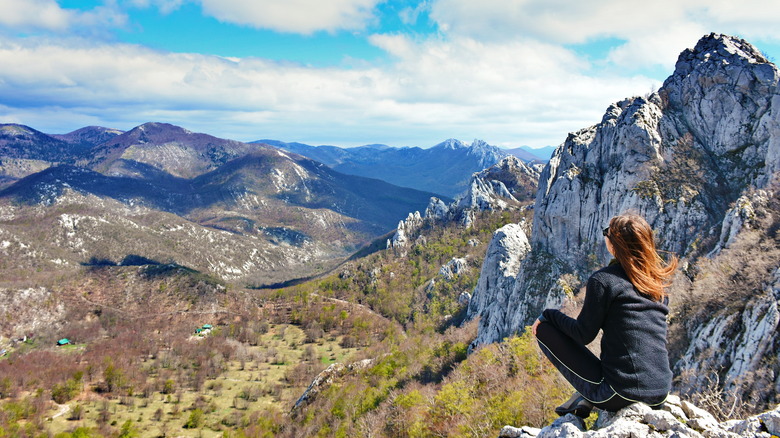 Hiker in landscape of Velebit Mountains