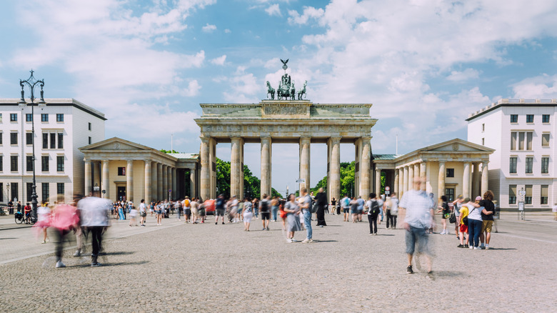 Travelers walking by Brandenburg Gate in Berlin