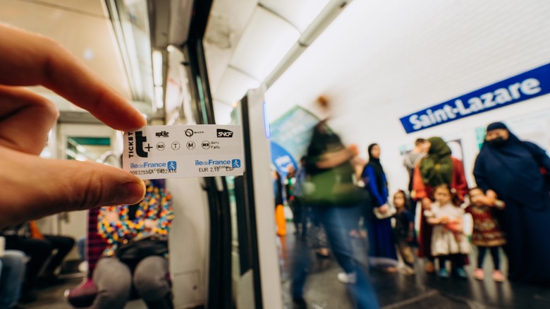 Hand holding Paris train ticket