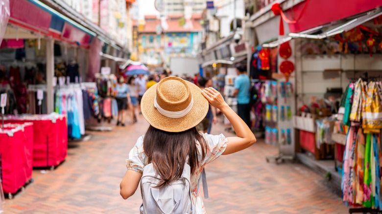 Tourist walking through Chinese market