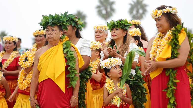 Indigenous Hawaiians wear traditional outfits