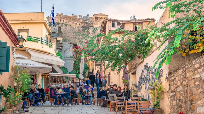 busy sidewalk cafe below Acropolis