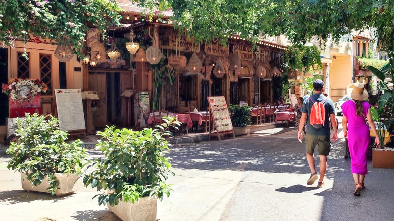 couple walking by Athens restaurants