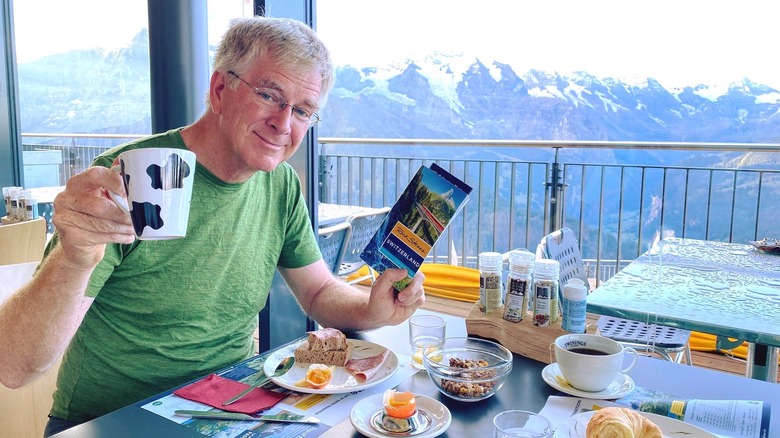 Rick Steves having breakfast in mountains