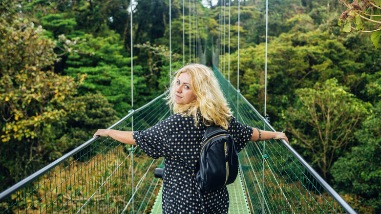 Traveler walking on suspension bridge