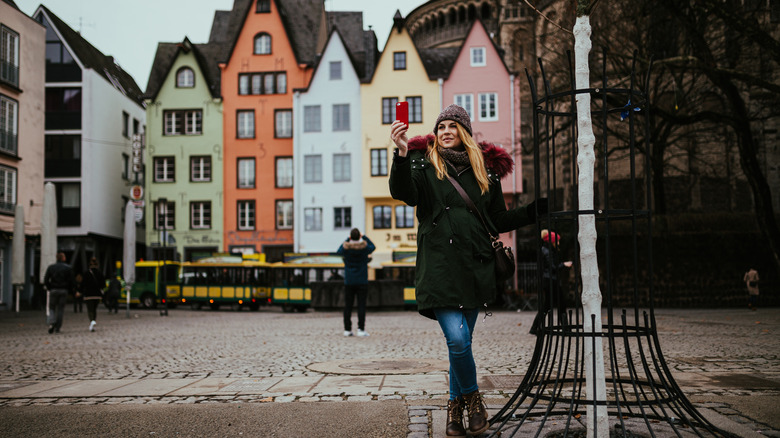 Woman in winter coat takes selfie