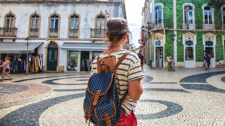 tourist standing in Portuguese plaza