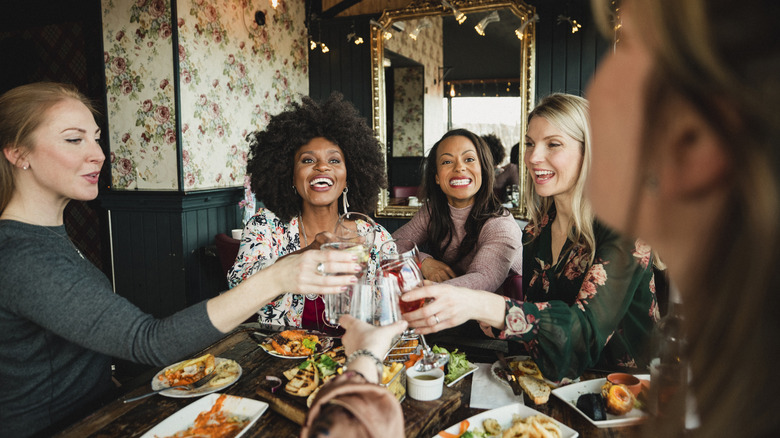 women toasting at restaurant table