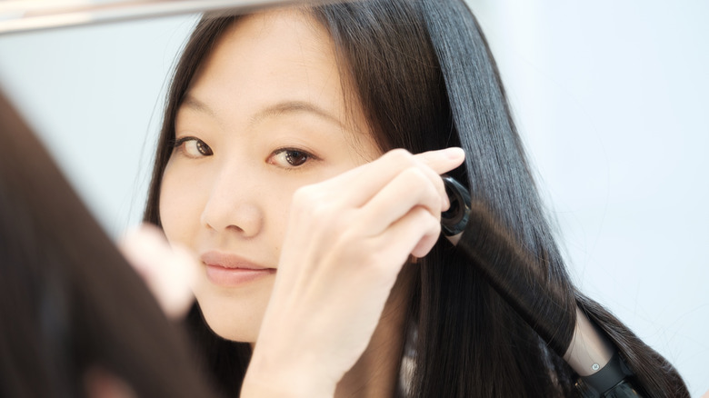 Woman using curling iron