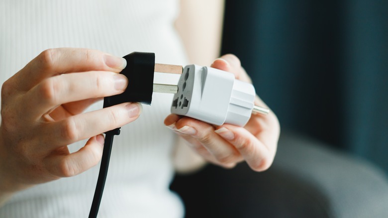 Person using power adapter