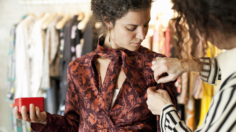 Tailor adjusting Italian clothes on a client in Rome