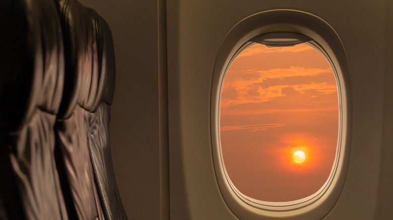 Sun setting through airplane window