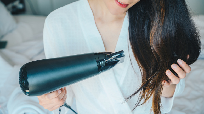 Traveler blow drying their hair