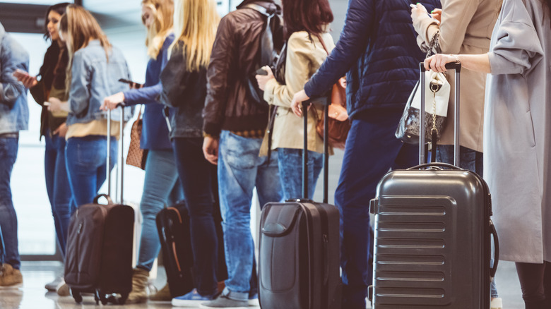 people with suitcases in airport