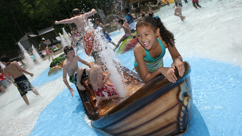 Girl playing on water feature at Splash Country