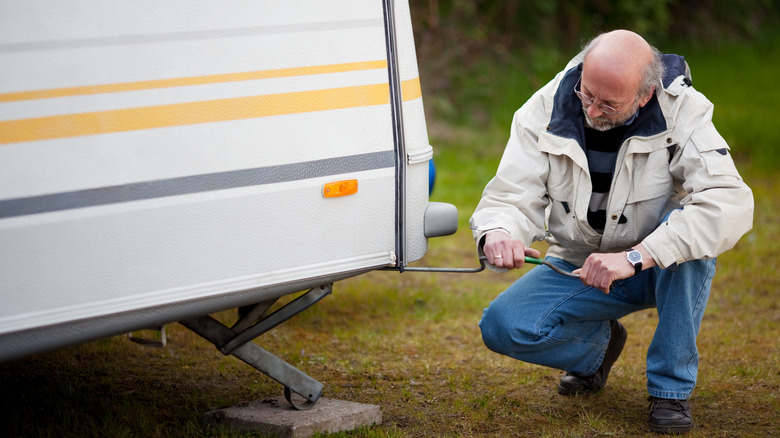 Senior man repairing RV camper