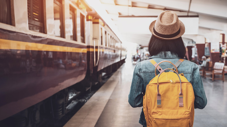 woman yellow backpack train